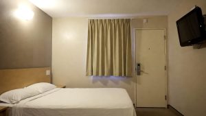 Clean and safe budget motel room interior, an example of accommodation provided through emergency vouchers.