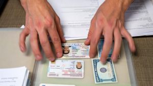 A collection of important documents such as ID cards and social security cards are required for housing voucher applications.
