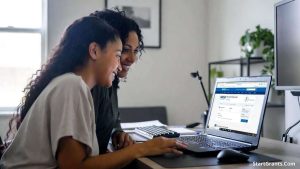 A diverse mother and daughter sitting at a computer desk, focused on successfully submitting the FAFSA federal financial aid form.