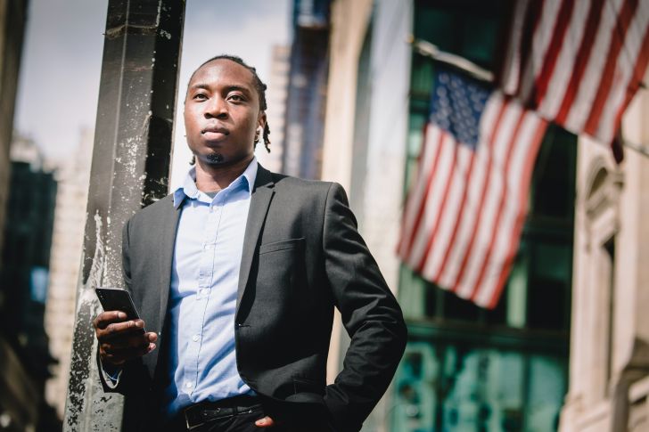 Photo by Ketut Subiyanto: https://www.pexels.com/photo/confident-black-businessman-with-smartphone-against-facade-of-building-with-us-flags-4560138/ what-government-grants-do-i-qualify-for