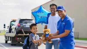 A tow truck picking up a donated car to fund Make-A-Wish through the Wheels for Wishes program.