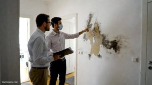 A homeowner consulting an inspector before applying for government grants for homeowners with mold.