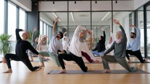 A diverse group of adults practicing yoga together in a bright, modern studio