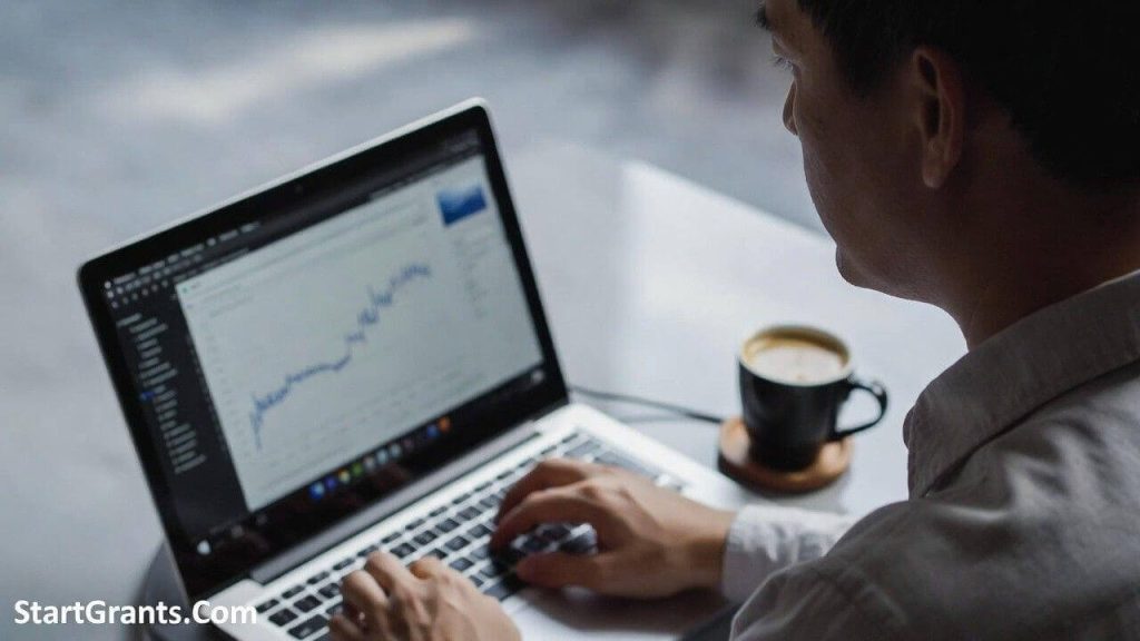An adult learner confidently studying a free online college course on a laptop to prepare for returning to school.