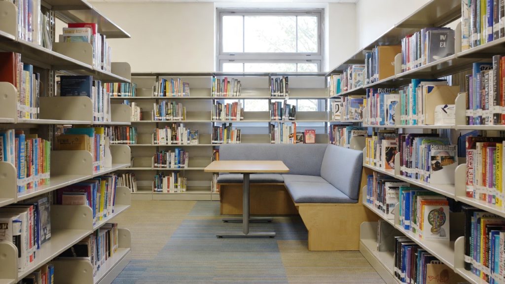 Renovated school library reading nook featuring accessible shelving and soft seating funded by Tocker Foundation.