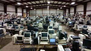 Volunteers sorting donated computers at a non-profit refurbishing center for low-income families.