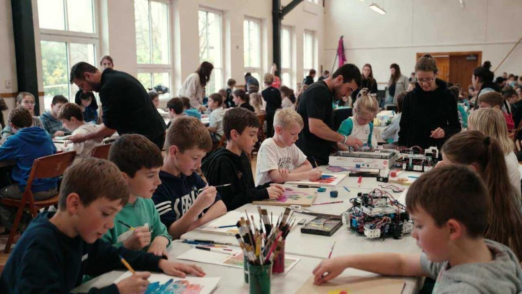 A group of homeschooled children from different families participating in a group art class funded by a local homeschool co-op grant.