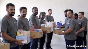 Corporate volunteers delivering boxes of tangible in-kind donations to a local nonprofit organization