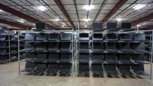 Rows of used computers for sale at a university surplus warehouse.