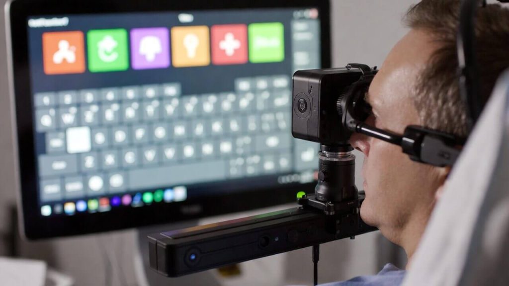 Person using eye-tracking technology to control a computer screen.
