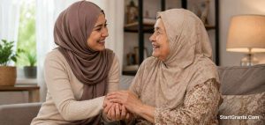 A younger Muslim woman respectfully holding the hands of an elderly woman.