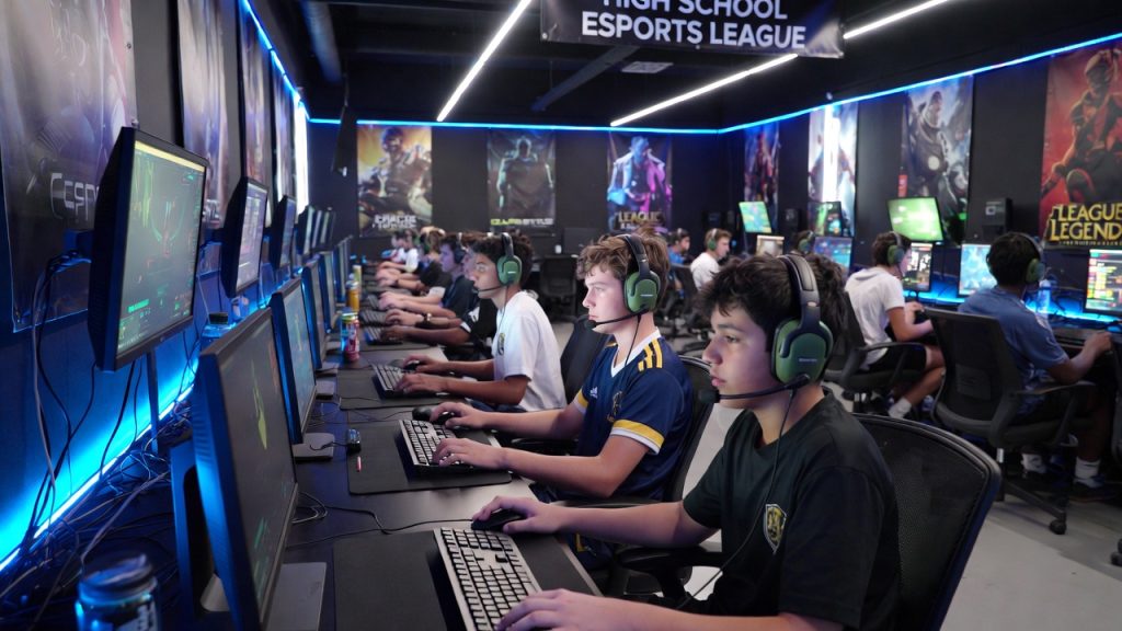 High school esports team practicing in a computer lab funded by gaming grants.
