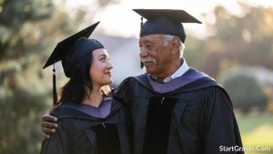 A veteran father and his daughter graduating together, symbolizing the generational impact of military education grants.