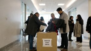 A community winter coat donation drive at an office to help local homeless shelters.