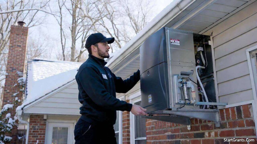 A certified HVAC contractor installing a new electric heat pump funded by a government grant.