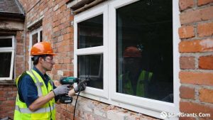 A contractor installing new units funded by government grants for energy efficient windows.