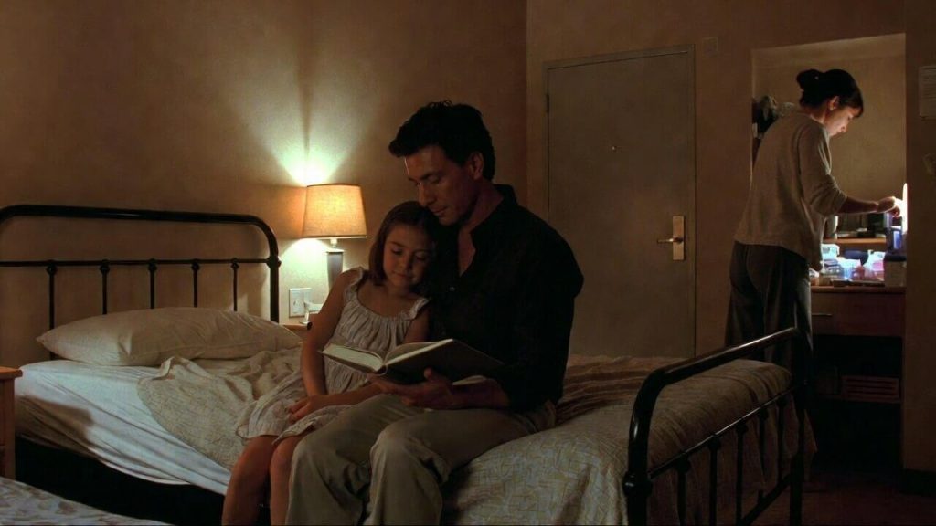 A homeless family (father, mother, and child) staying together in a safe, clean, private "intact family" shelter unit.