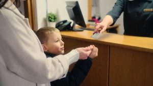 Homeless family checking into a motel using a non-congregate emergency voucher.