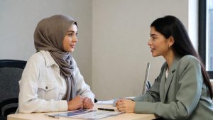 Muslim woman consulting with a social worker about housing assistance and religious accommodations.