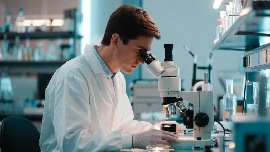 Embryologist performing a procedure in a lab, representing clinical trials that offer free IVF treatment.