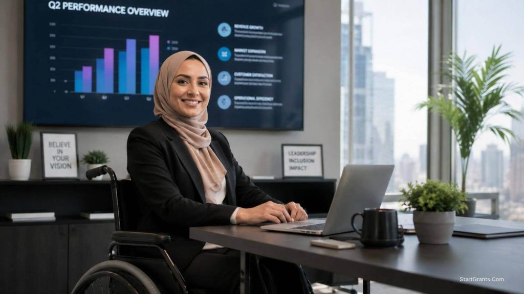 A female entrepreneur in a wheelchair working confidently at her desk.