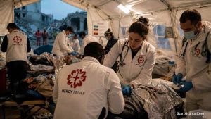 Medical professionals from a global charity providing emergency triage care in a disaster zone.
